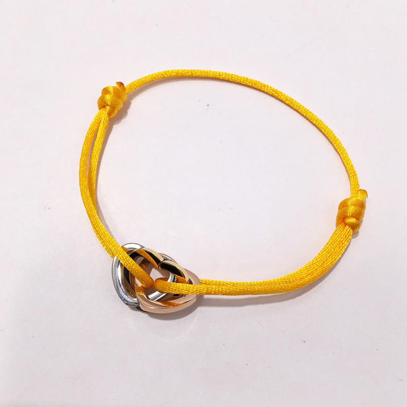 The hand rope is fashionable and does not fade. Titanium steel bracelet has three rings and three colors. Hollow love-shaped male and female couples colored hand rope.