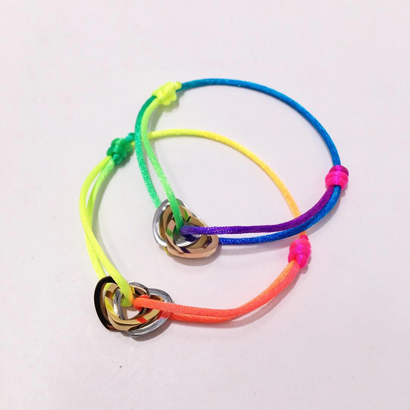 The hand rope is fashionable and does not fade. Titanium steel bracelet has three rings and three colors. Hollow love-shaped male and female couples colored hand rope.