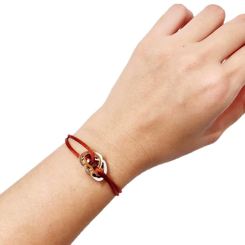 The hand rope is fashionable and does not fade. Titanium steel bracelet has three rings and three colors. Hollow love-shaped male and female couples colored hand rope.